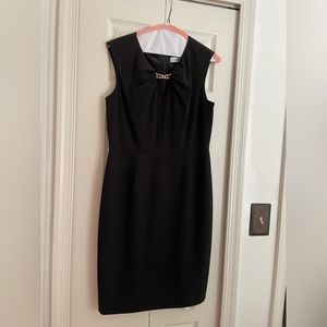 Calvin Klein Knee length V-neck shift dress with gold detail.